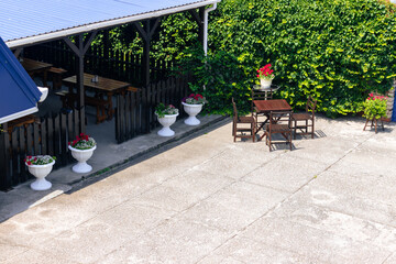 Table and chairs in the open air. Small restaurant or bar with a wide terrace