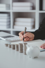Person with pile of coins and piggy bank, money saving concept for future use and financial...