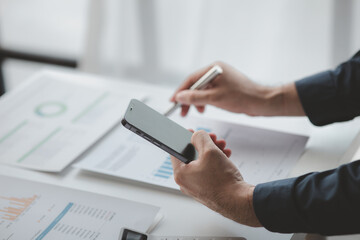 Businessman in a private office at his company and is reviewing company financial documents, senior management checking financial information for accuracy. Financial management.