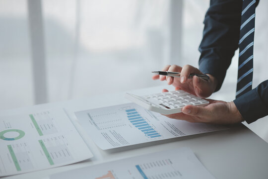 Businessman In A Private Office At His Company And Is Reviewing Company Financial Documents, Senior Management Checking Financial Information For Accuracy. Financial Management.