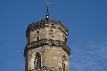 West tower of the collegiate church in Stuttgart delicate clouds in the deep blue sky