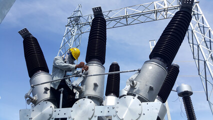 Electrical technician tightening of 115kV Hybrid Switchgear Connecting Rods after Installation