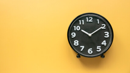 Concept of time, reminder, countdown, alert, deadline. Wall clock isolated on yellow background.Copy space.