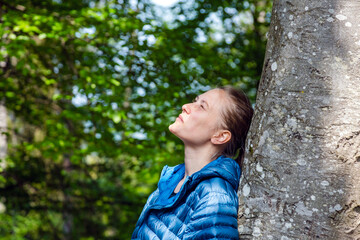 Person Leisurely Gazes up at Tree Amidst Spring Foliage