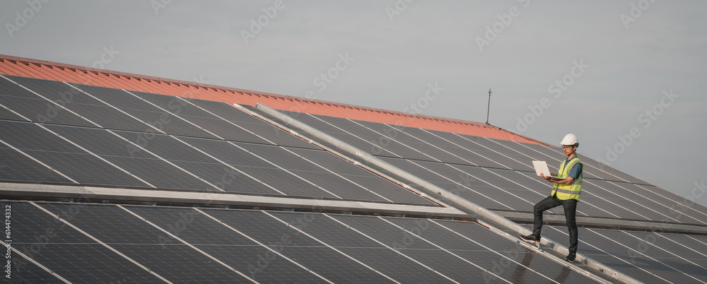 Wall mural service engineer checking solar cell on the roof for maintenance if there is a damaged part. enginee