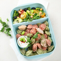 Vegetarian food. Colored dumplings in a plate/on board.