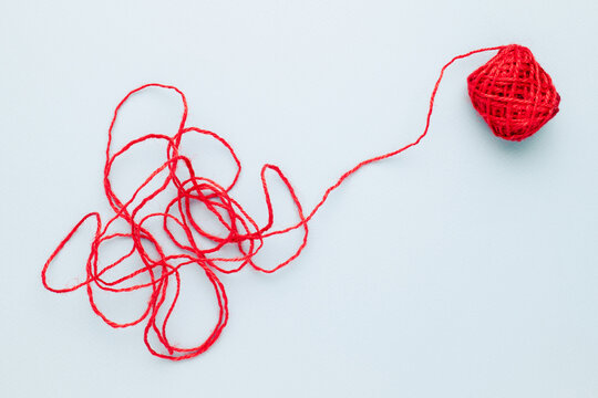 Red jute rope with complicated end of rope, unravels the confused rope