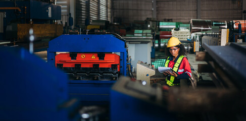 Industrial worker inspecting and check up machine at factory machines.Technician working in metal sheet at industry. Foreman checking Material or Machine.