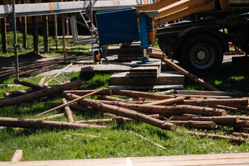 Process of building rustic house in the park. Lot of log trunks