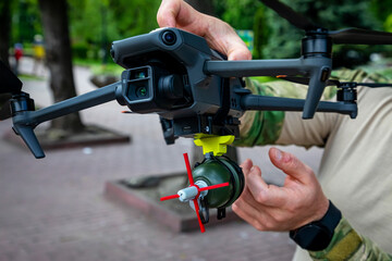 Soldier ties grenade blow up an enemy with military drone. Concept using quadrocopters in smart war in Ukraine.