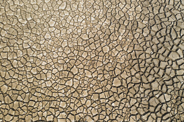 Dry cracked earth texture of Lokvarsko lake in Gorski kotar, Croatia, drone overhead view