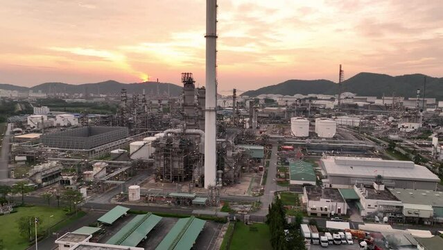 Aerial view of chemical oil refinery plant, power plant on sunset sky background , Gas Oil depot, Crude Oil Refinery Plant Steel Pipe line and Chimney Cooling tower, Chemical or Petrochemical sunset.	