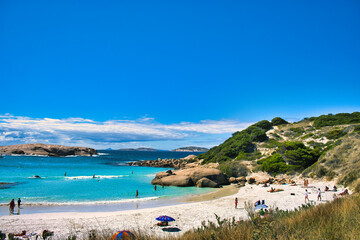 The idyllic Twilight Beach near Esperance, Western Australia, with holiday makers swimming in the sea and sunbathers relaxing on the beach
