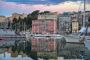 Fototapeta na wymiar Corsica, Bastia, typical houses in the harbor in summer, sunset 