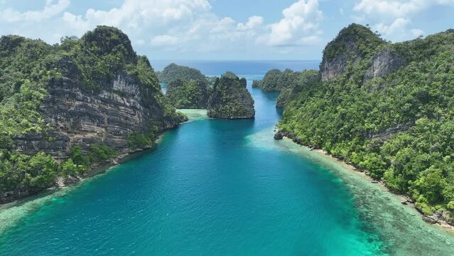 Dramatic limestone islands, eroded over millions of years, rise from Raja Ampat's seascape. This area of eastern Indonesia is known for its spectacular marine biodiversity.