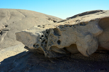 In the desert lies a huge boulder with an eroded surface. Global warming on the dehydration of the...