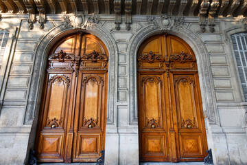 Old ornate doors in Paris - typical old apartment buildiing.