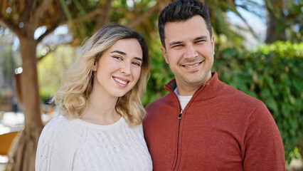 Obraz premium Man and woman couple smiling confident standing together at park