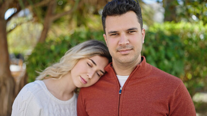 Obraz premium Man and woman couple smiling confident standing together at park