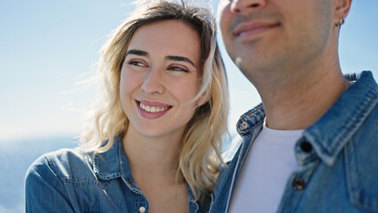 Man and woman couple smiling confident standing together at seaside