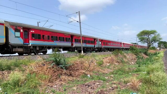 Passenger Train hauled by a WAP7 loco heads towards Pune, at Uruli near Pune India.