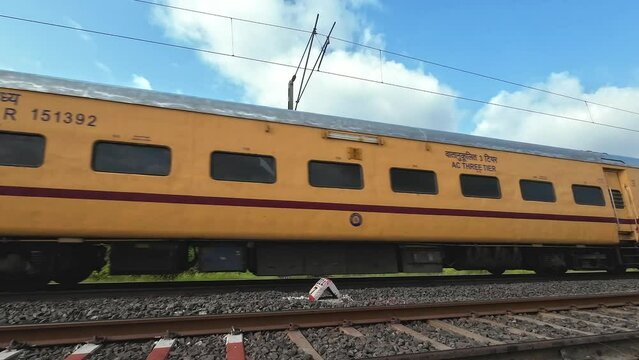 Passenger train hauled by a WAP4 electric loco heading towards Pune, at Uruli near Pune India.