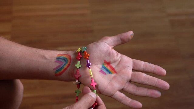 hand drawn rainbow symbol of peace and freedom with catholic rosary with colored crosses in prayer - Lgbt gay pride symbol 