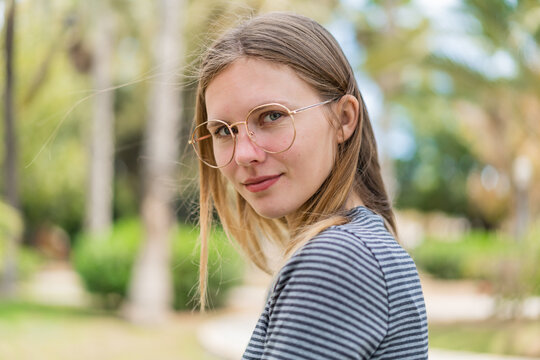 Young blonde woman with glasses at outdoors . Portrait