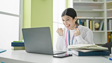 Young beautiful hispanic woman doctor having video call with winner expression at library university
