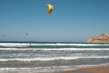 Different wake boarders surfing in the sea at the Prasonisi Beach at Rhodes Island.