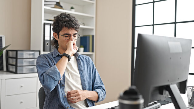 Young hispanic man business worker using computer coughing at office