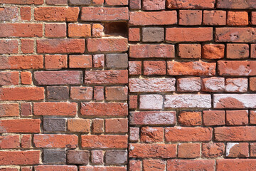 Join of two sections of old red brickwork