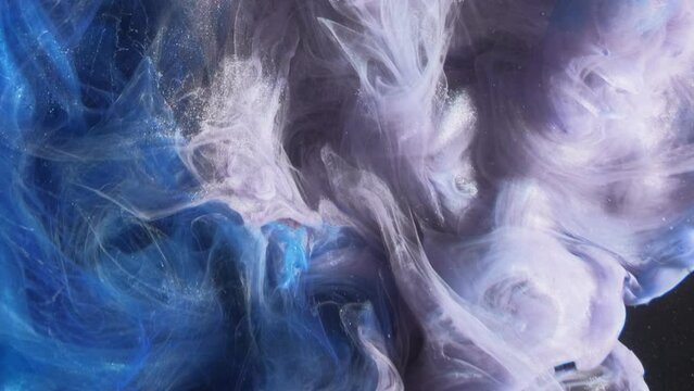 Ink water. Smoke splash. Creative transition. Blue purple color glitter vapor explosion cloud wave spreading motion on black abstract art background.
