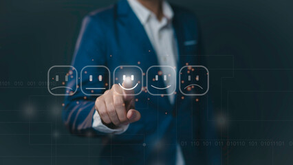 Businessman pressing smiley face emoticon on virtual touch screen. Customer service evaluation concept.review survey quality rating feedback, user satisfaction