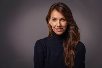 Obraz premium Studio portrait of a beautiful middle-aged woman looking at the camera
