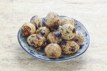 Raw quail eggs heap in the bowl