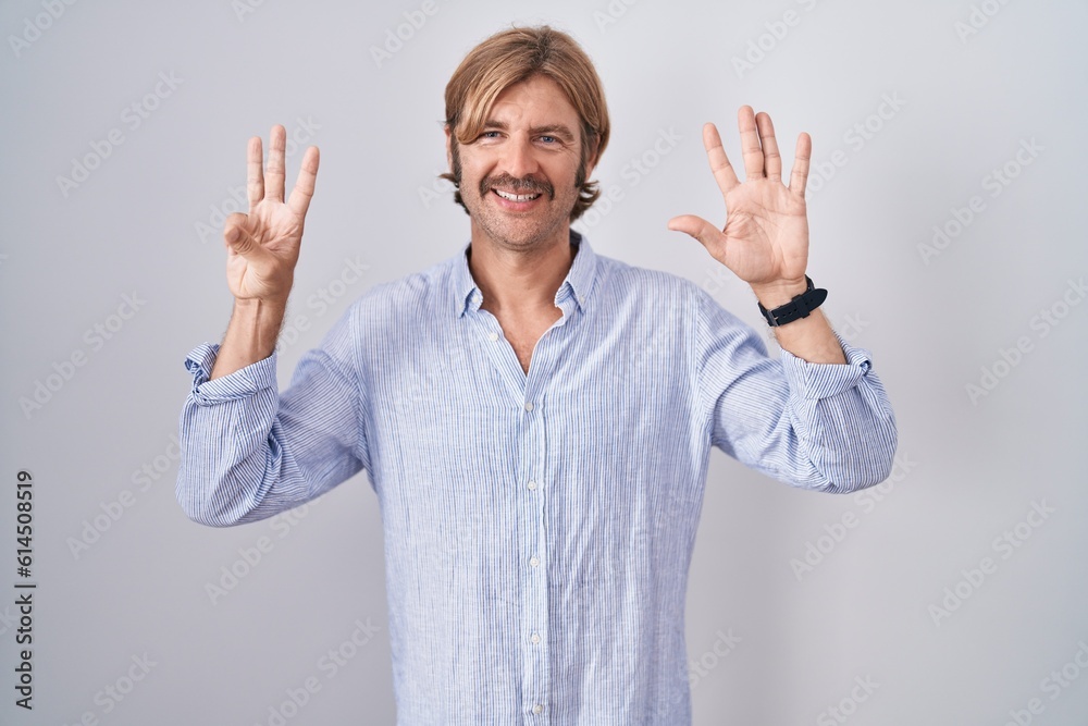 Canvas Prints Caucasian man with mustache standing over white background showing and pointing up with fingers number eight while smiling confident and happy.