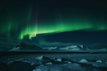 Fototapeta na wymiar aurora borealis shining in the sky over snowy mountains in winter in Iceland