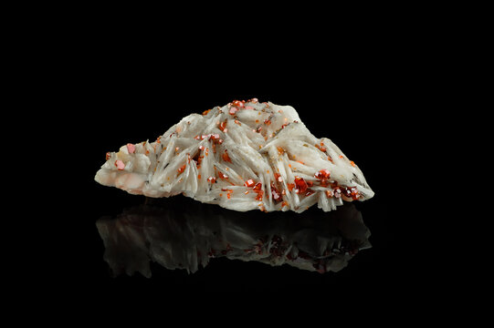 orange vanadinite on baryte isolated on black background. macro detail texture. close-up polished semi-precious gemstone.