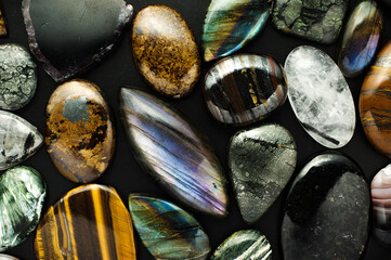 cabochon gemstone mix. macro detail texture background. close-up polished semi-precious gemstone.