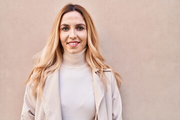 Fototapeta premium Young blonde woman smiling confident standing over isolated white background