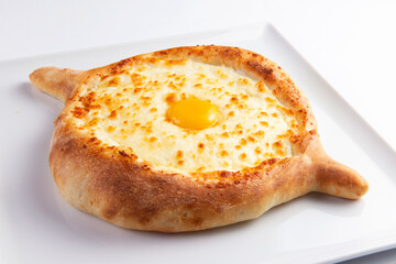 Traditional pie with cheese and egg yolk. Khachapuri.