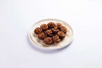 Grilled champignon mushrooms. On a white background.