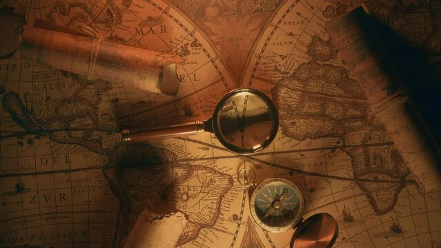 Compass and magnifier on a old vintage world map with countries and continents. Retro style. Concept of geography or global history and cartography. Wars of conquest and navigation. 4K ProRes