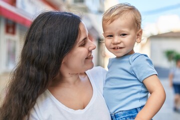 Mother and son smiling confident standing at street