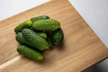 Fresh farm cucumbers in the background. Close up