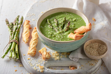 Vegan and hot creamy asparagus soup as healthy and appetizer.