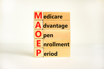 MAOEP symbol. Concept words MAOEP medicare advantage open enrollment period on wooden block. Beautiful white background. Medical MAOEP medicare advantage open enrollment period concept. Copy space.
