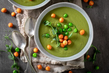 Healthy pea soup with cream and peas puff.