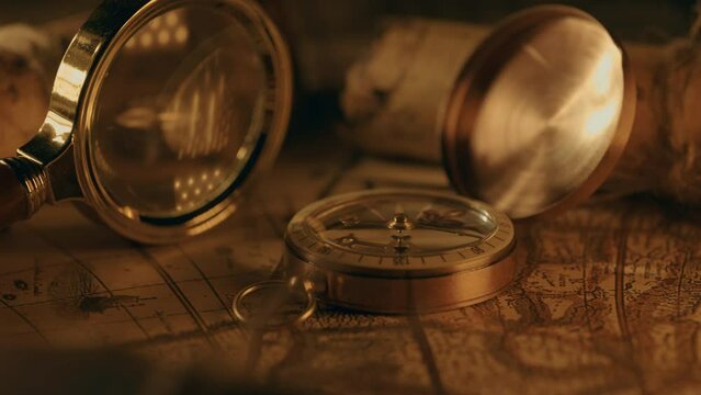 Compass and magnifier on a old vintage world map with countries and continents. Retro style. Concept of geography or global history and cartography. Wars of conquest and navigation. 4K ProRes